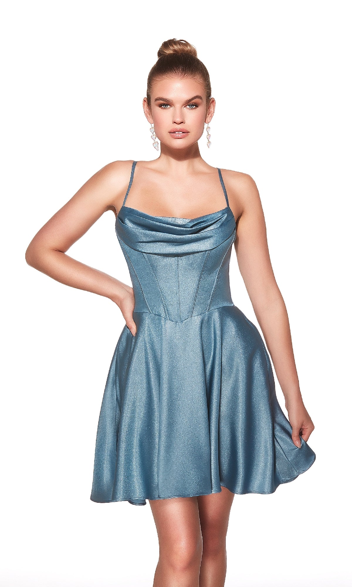 A woman stands against a white background wearing the Alyce 30047: a light blue, sleeveless fit-and-flare short homecoming dress with a cowl neckline, spaghetti straps, and a lace-up open back.